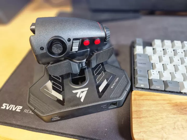 A throttle device seen from the backside with buttons, dials and switches